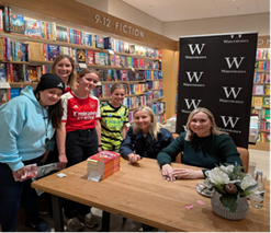 Group photo of 2 Y6 pupils at book signing with England and Arsenal woman team captains