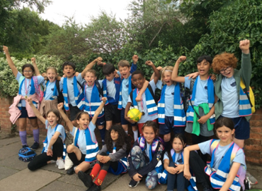 Group of Tetherdown pupils waving in PE kit